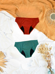 lot de  culottes à plat sur un lit de couleurs rouge et verte